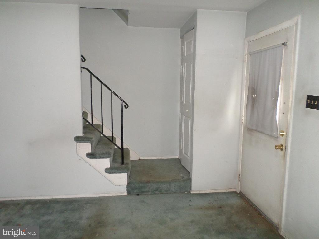 3407 Santee Road Baltimore, MD 21236 - Photo 6 of 22 wooden floor with white walls and stairs