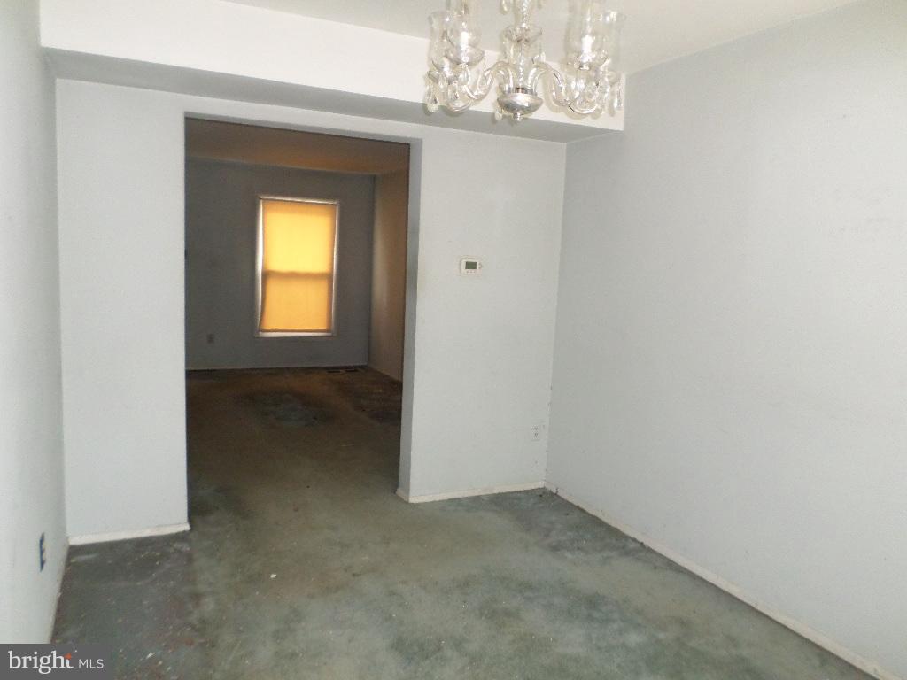 3407 Santee Road Baltimore, MD 21236 - Photo 8 of 22 an empty room that has a chandelier