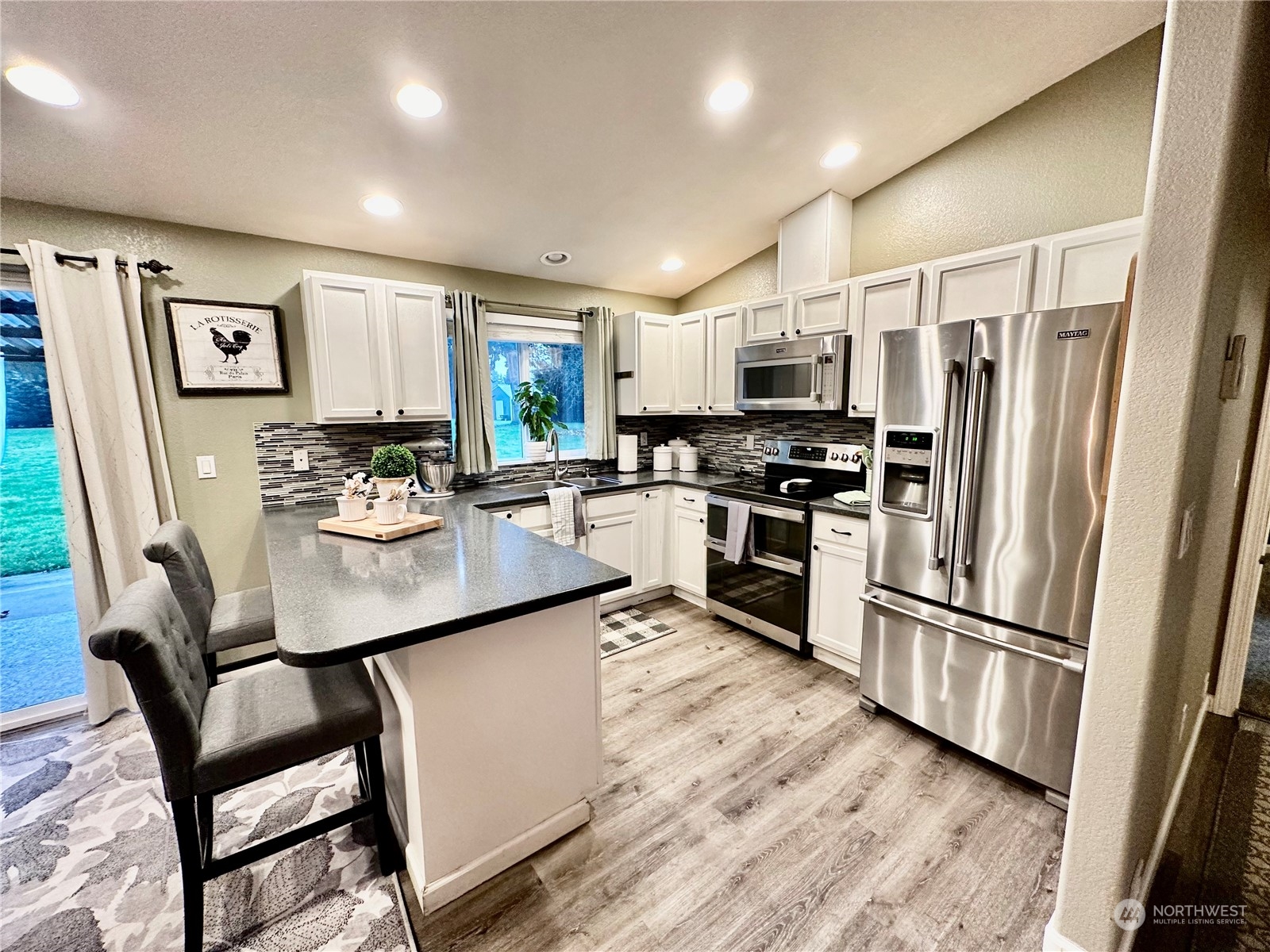 18120 Sunshine Lane Southwest Rochester, WA 98579 - Photo 13 of 39 a kitchen with stainless steel appliances a refrigerator stove microwave and sink