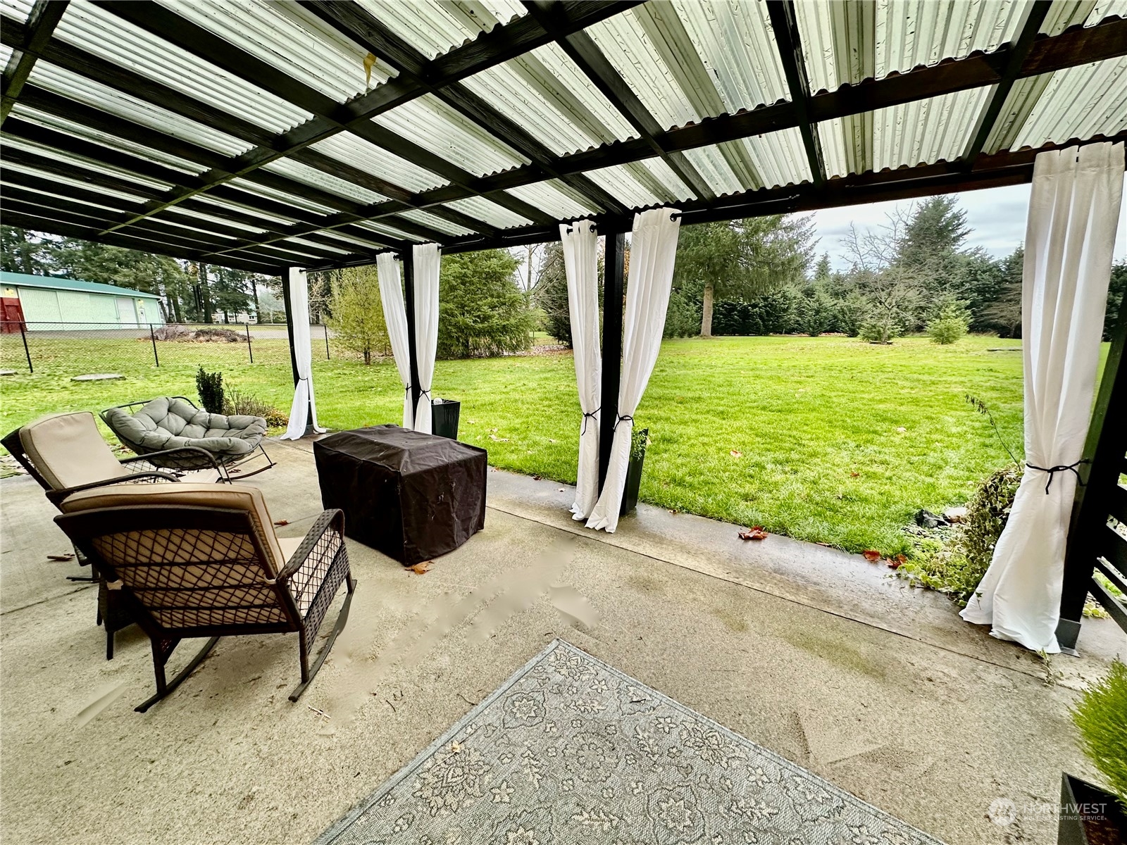 18120 Sunshine Lane Southwest Rochester, WA 98579 - Photo 30 of 39 a view of a porch with furniture and a yard