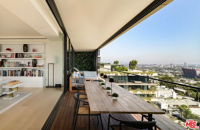a view of a balcony with table and chairs