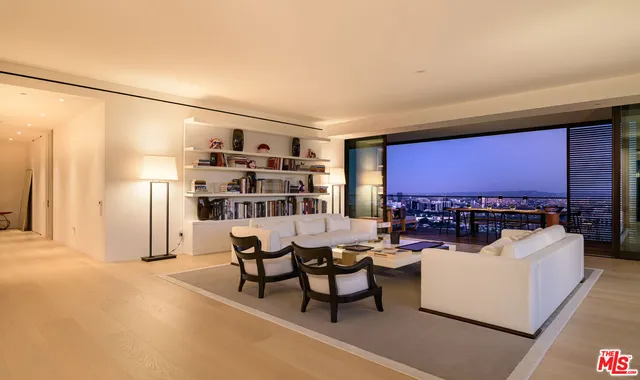 a living room with furniture a rug and a large window