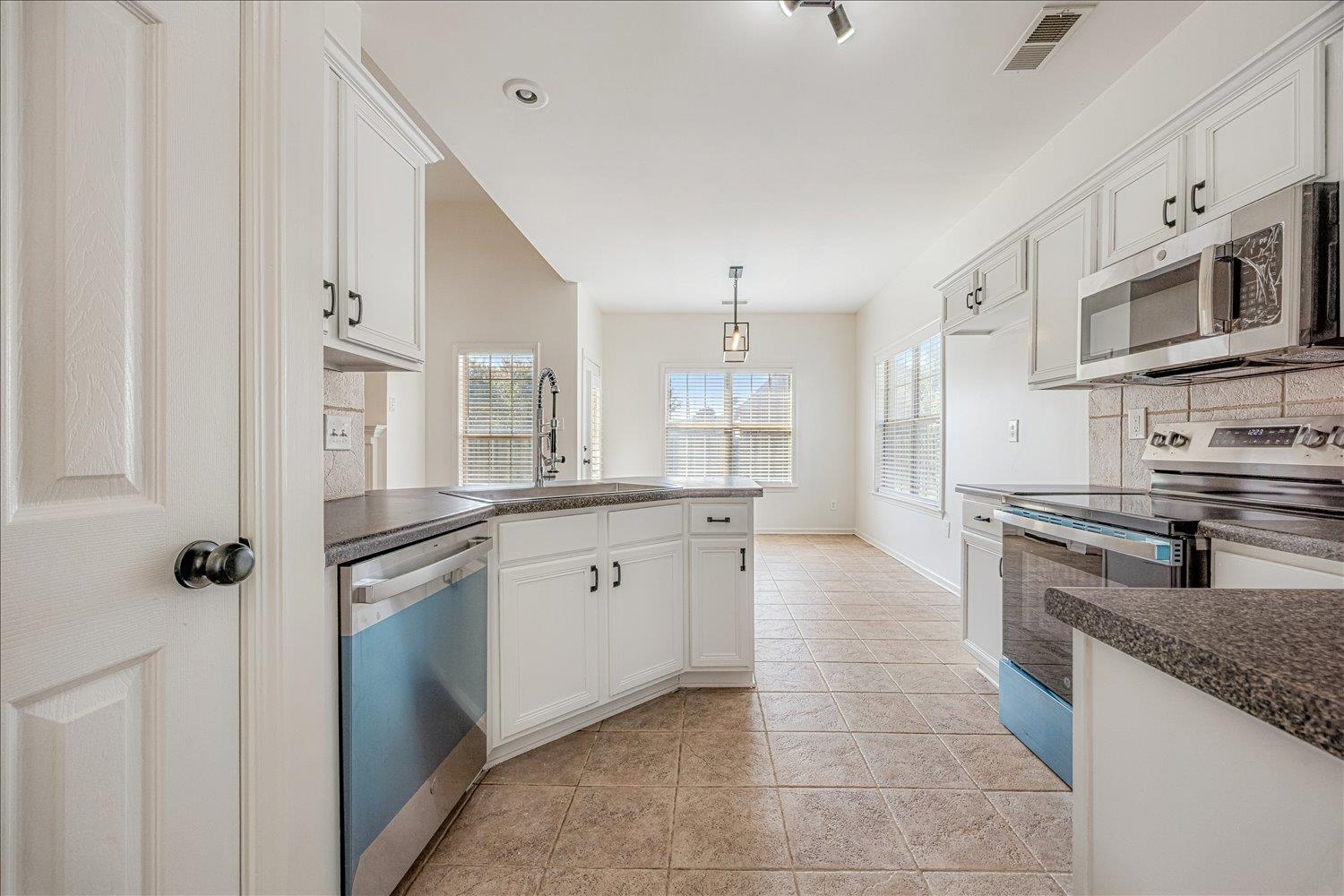 8453 Thor Road Memphis, TN 38018 - Photo 16 of 29 a large kitchen with stainless steel appliances granite countertop a stove and a sink