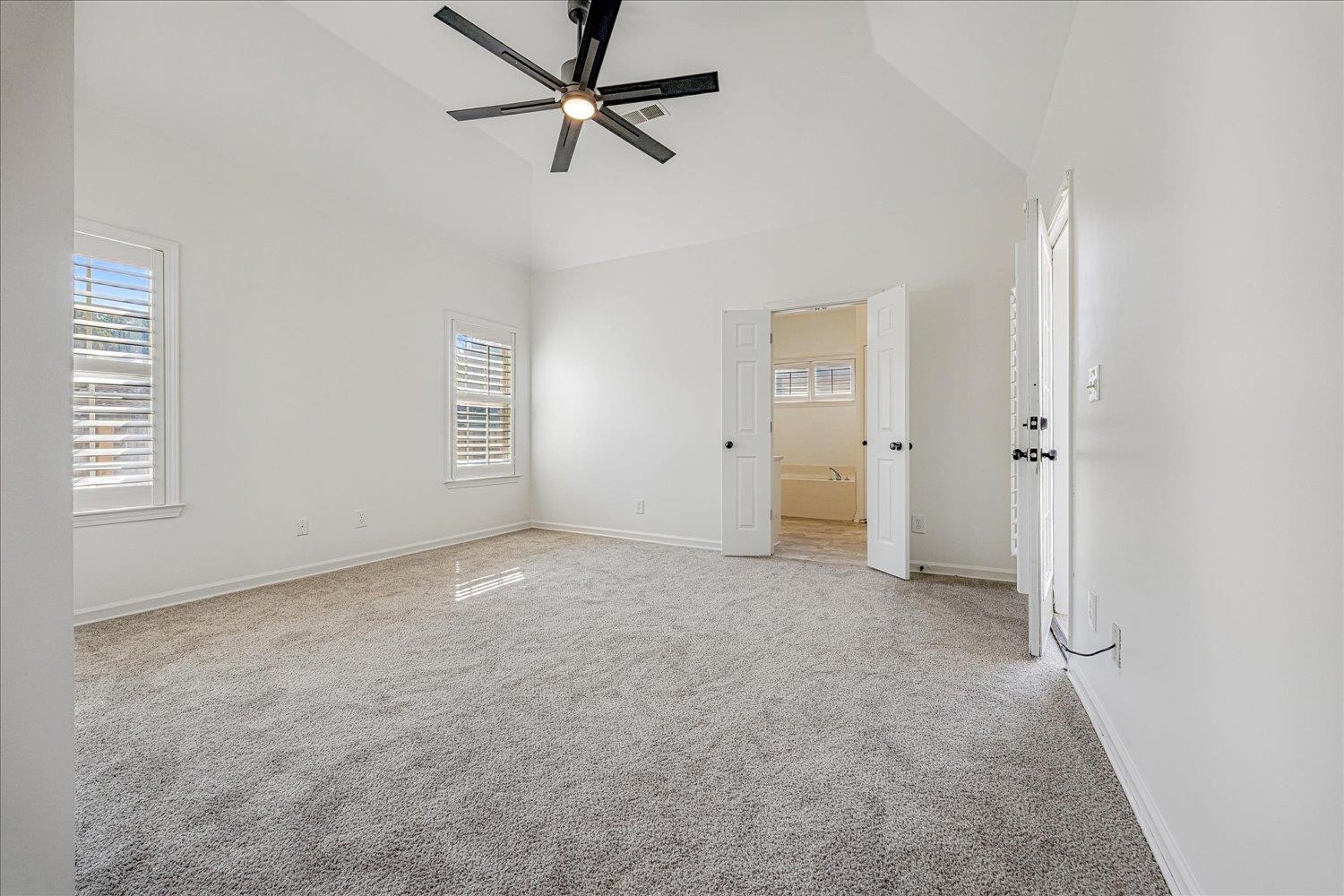 8453 Thor Road Memphis, TN 38018 - Photo 17 of 29 an empty room with chandelier fan and windows