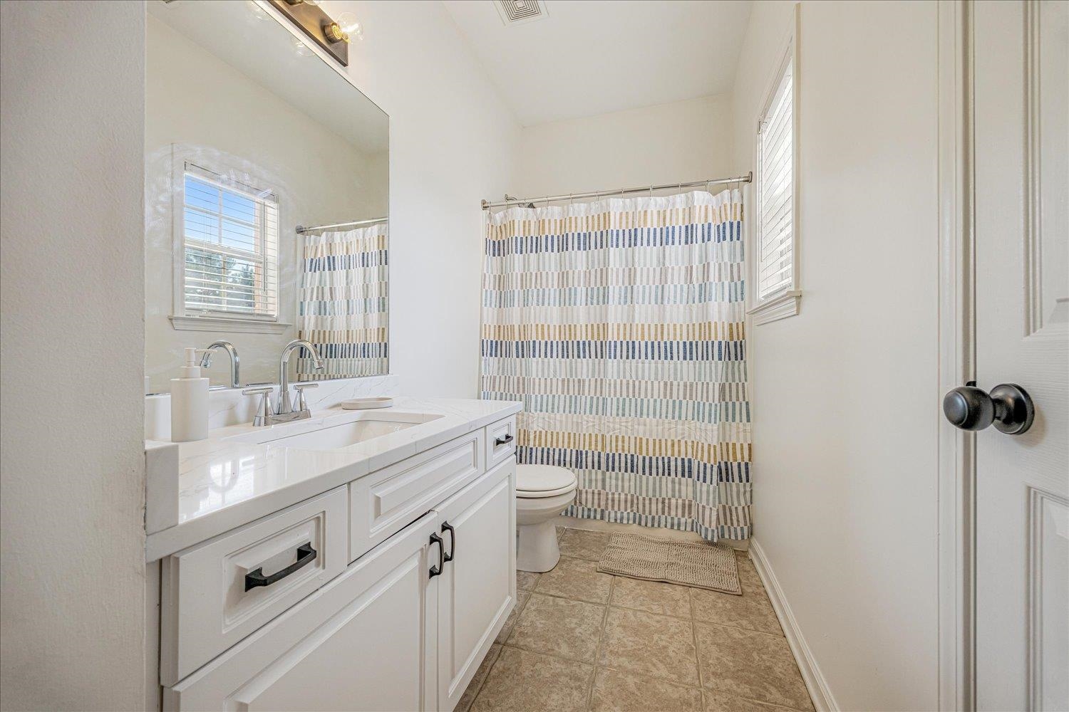 8453 Thor Road Memphis, TN 38018 - Photo 20 of 29 a bathroom with a double vanity sink toilet and shower