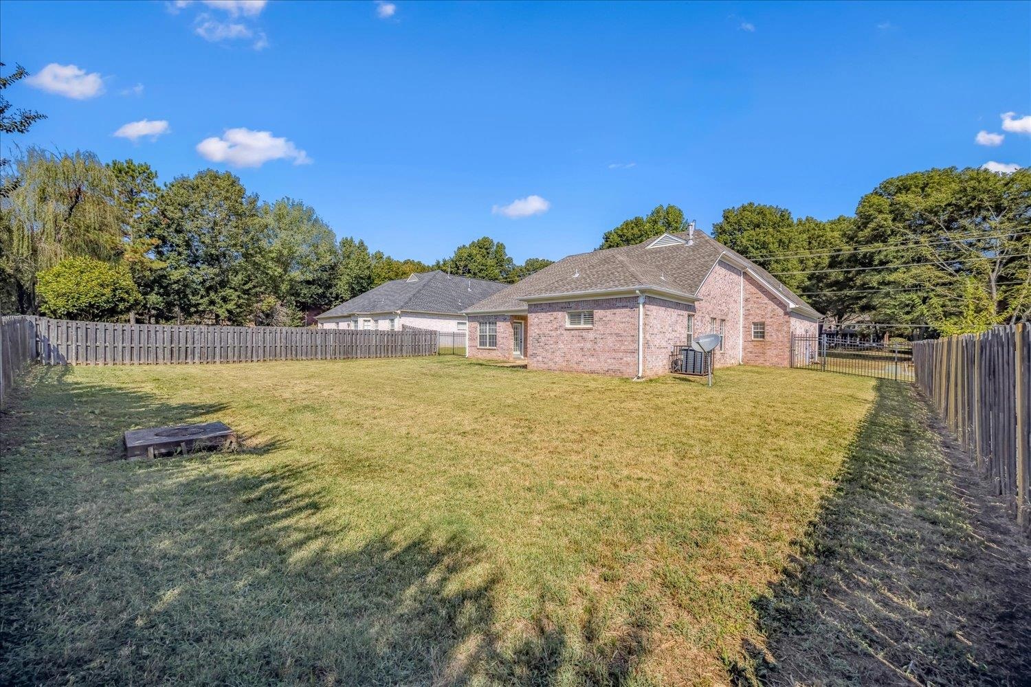 8453 Thor Road Memphis, TN 38018 - Photo 27 of 29 a blue swimming pool is in a backyard of a house