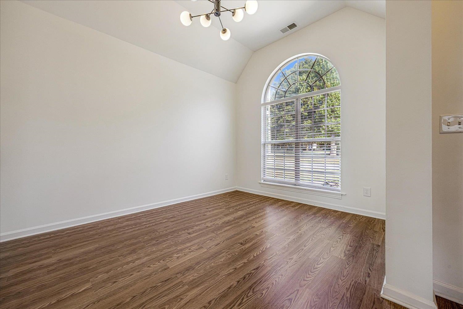 8453 Thor Road Memphis, TN 38018 - Photo 10 of 29 wooden floor in an empty room with a window