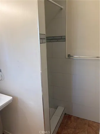 a bathroom with a glass shower door