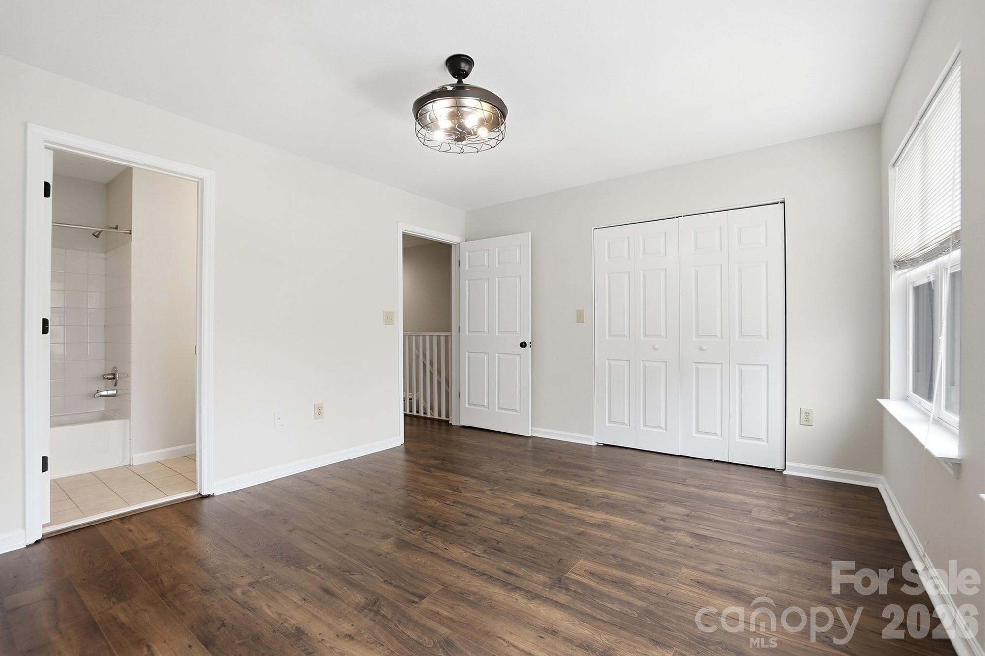 711 Stone Village Drive Fort Mill, SC 29708 - Photo 31 of 46 a view of an empty room with wooden floor and a window