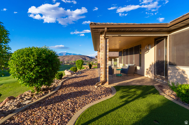 2212 Chippenham Court St. George, UT 84770 - Photo 33 of 75 View of grassy yard with a patio and a mountain view