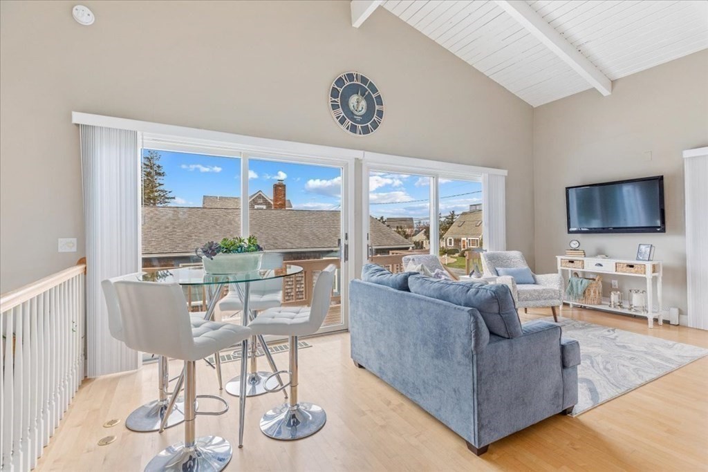 8 Feake Avenue Sandwich, MA 02563 - Photo 11 of 34 a living room with furniture a flat screen tv and a large window