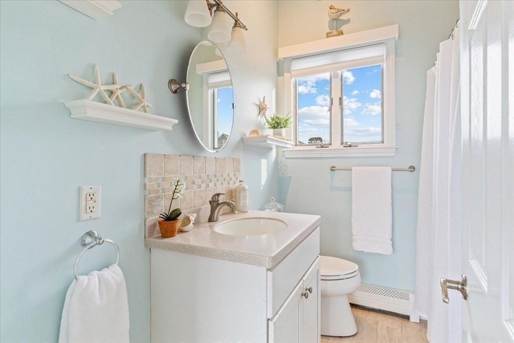 8 Feake Avenue Sandwich, MA 02563 - Photo 15 of 34 a bathroom with a toilet sink and mirror