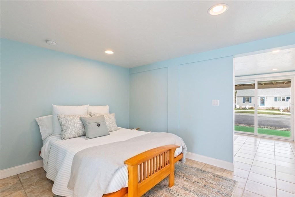 8 Feake Avenue Sandwich, MA 02563 - Photo 21 of 34 a bedroom with a bed and glass floor