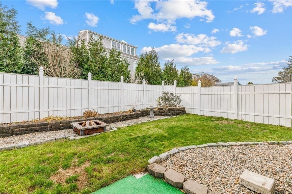8 Feake Avenue Sandwich, MA 02563 - Photo 29 of 34 a backyard of a house with table and chairs