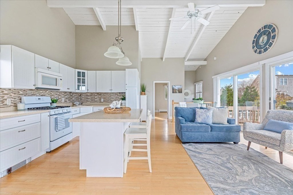 8 Feake Avenue Sandwich, MA 02563 - Photo 4 of 34 a large white kitchen with a large window a counter space a sink stainless steel appliances and cabinets