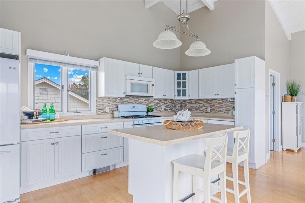 8 Feake Avenue Sandwich, MA 02563 - Photo 6 of 34 a kitchen with stainless steel appliances granite countertop a white cabinets and a refrigerator