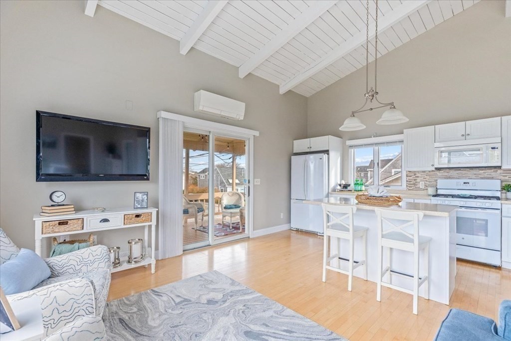 8 Feake Avenue Sandwich, MA 02563 - Photo 9 of 34 a living room with fireplace furniture and a flat screen tv