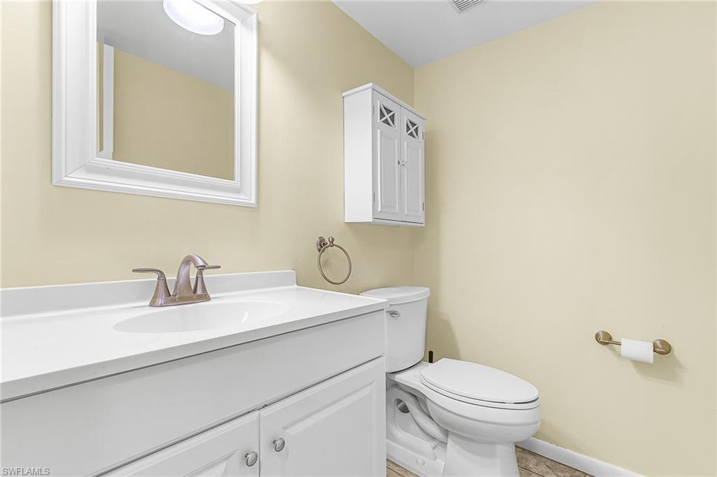 5917 Littlestone Court, Unit 115 North Fort Myers, FL 33903 - Photo 12 of 24 a bathroom with a sink a toilet and mirror