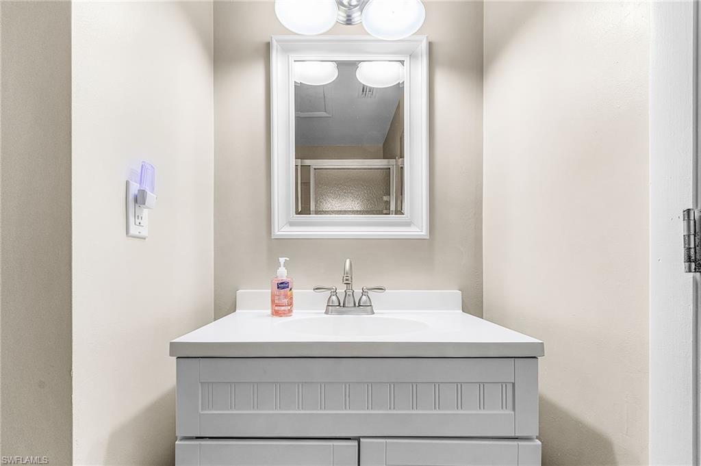 5917 Littlestone Court, Unit 115 North Fort Myers, FL 33903 - Photo 17 of 24 a bathroom with a sink and a mirror