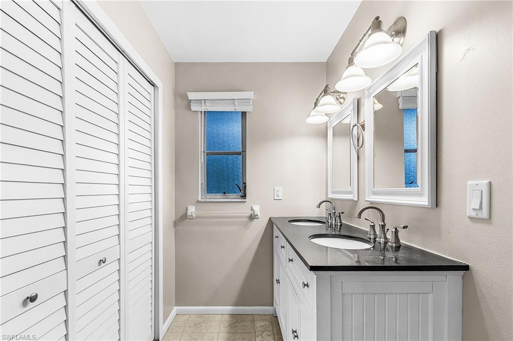 5917 Littlestone Court, Unit 115 North Fort Myers, FL 33903 - Photo 19 of 24 a bathroom with a sink and a mirror