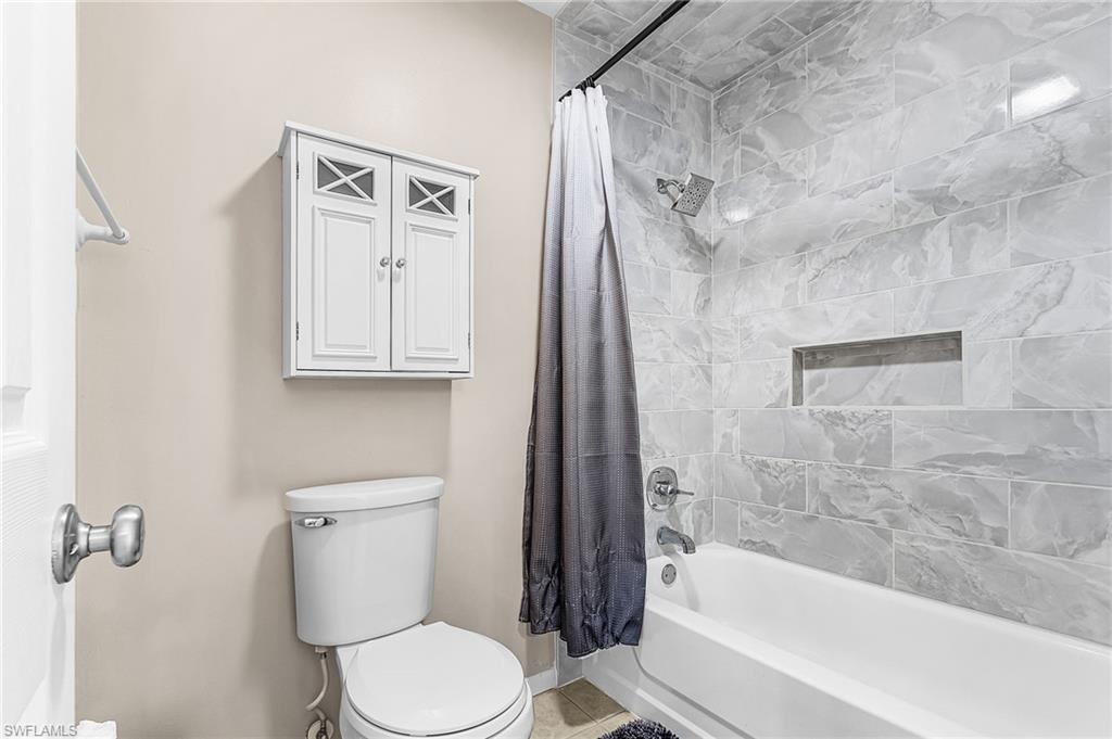 5917 Littlestone Court, Unit 115 North Fort Myers, FL 33903 - Photo 20 of 24 a bathroom with a toilet and a bathtub