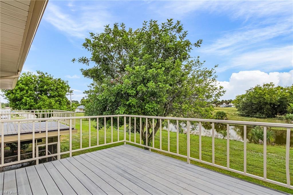 5917 Littlestone Court, Unit 115 North Fort Myers, FL 33903 - Photo 21 of 24 a view of balcony with wooden floor and fence
