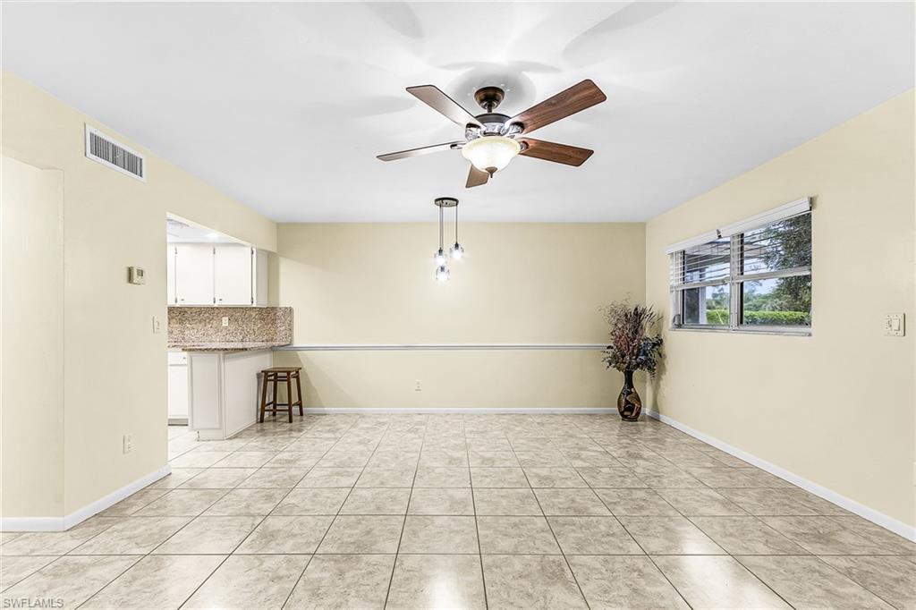 5917 Littlestone Court, Unit 115 North Fort Myers, FL 33903 - Photo 7 of 24 a view of a room with a window and a ceiling fan