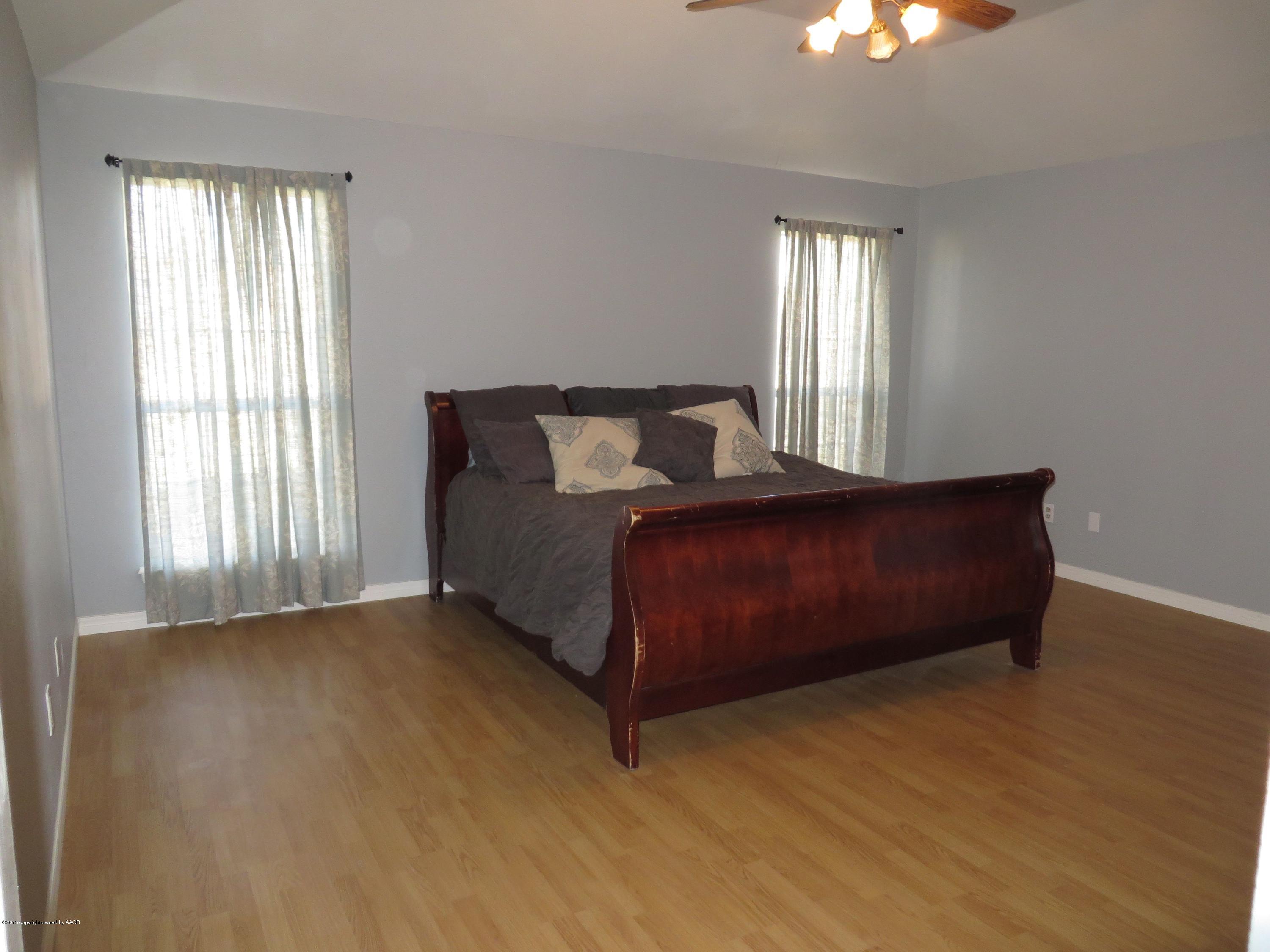 4213 Rincon Avenue Amarillo, TX 79110 - Photo 5 of 9 a living room with a bed furniture and a window