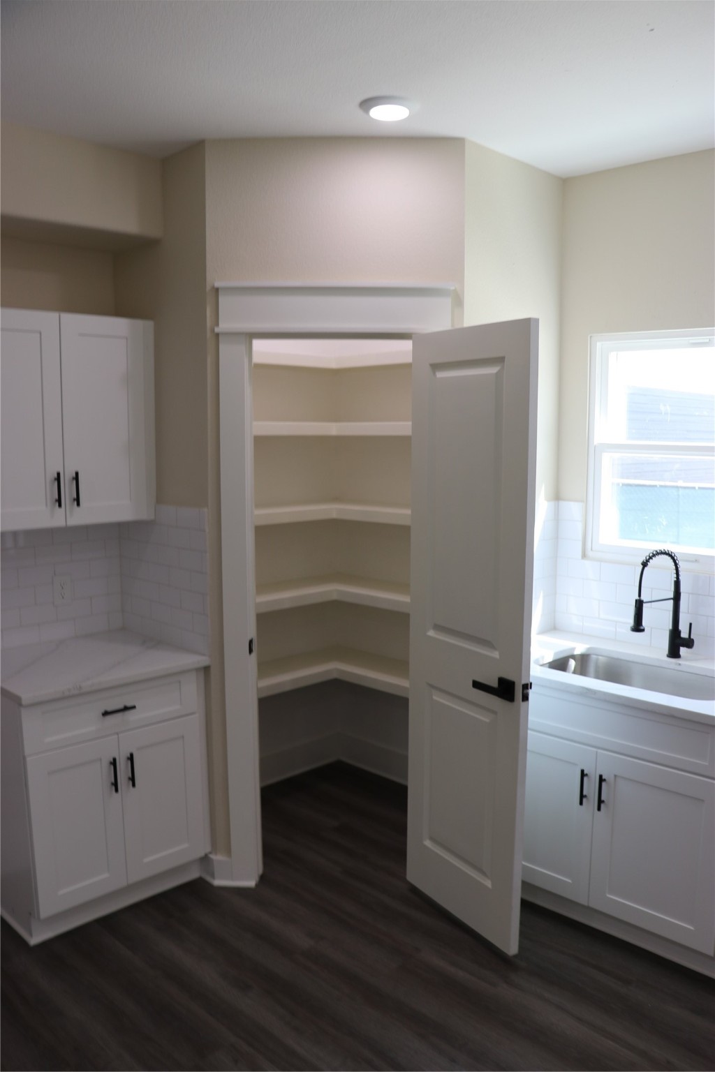 9441 Radio Road, Unit B Houston, TX 77075 - Photo 5 of 24 a view of a kitchen with wooden floor and cabinets