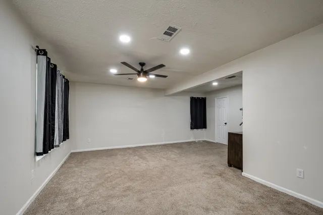an empty room with closet and windows