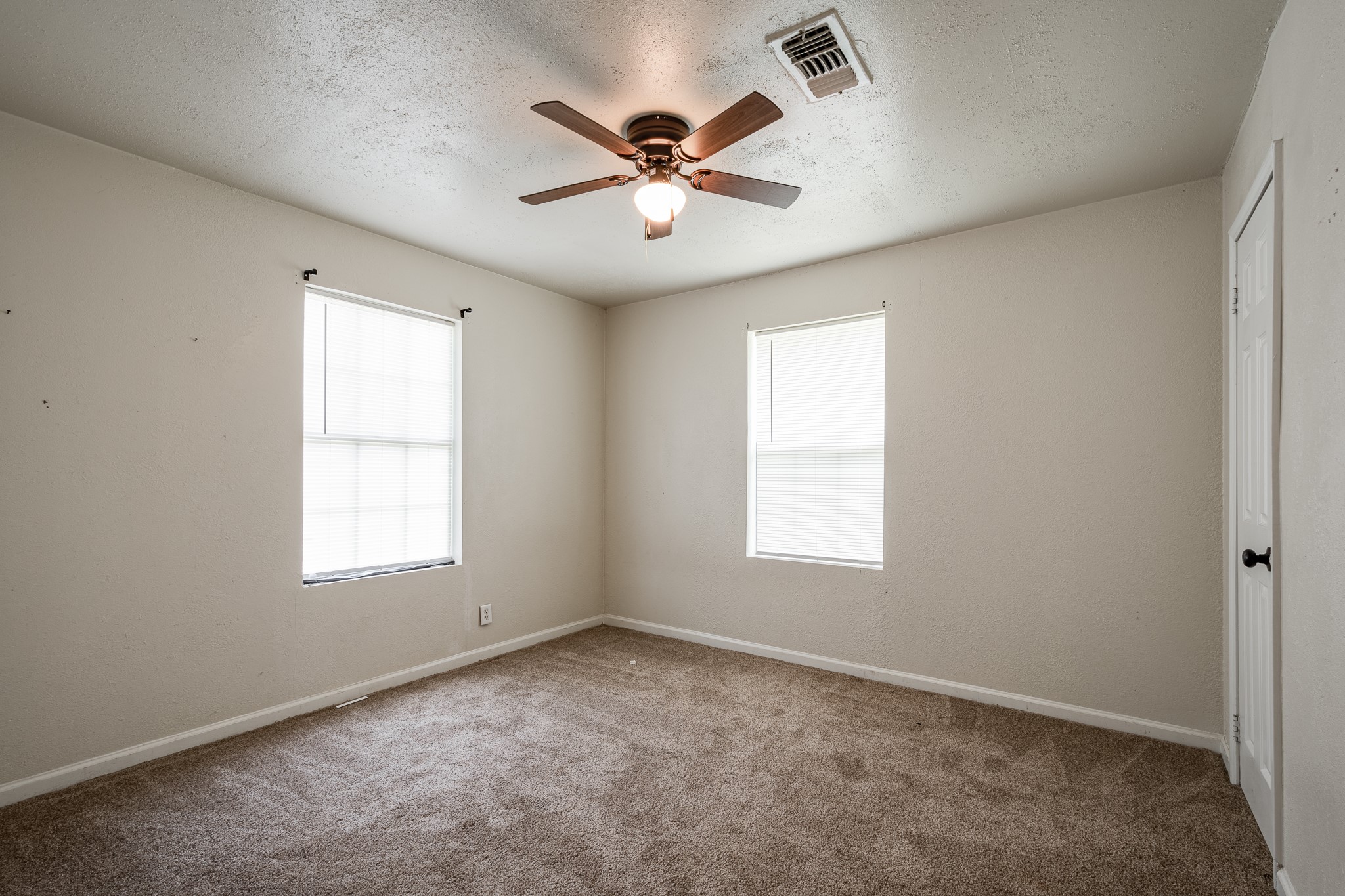 248 Fm-770 Liberty, TX 77575 - Photo 17 of 30 an empty room with window and ceiling fan