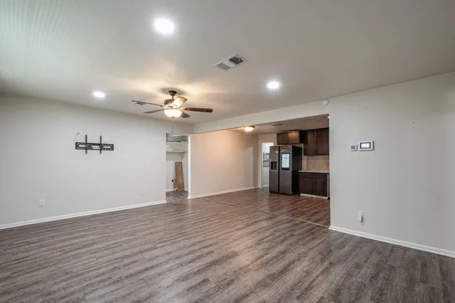 wooden floor in an empty room with a window