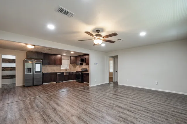 a view of a kitchen with a stove cabinets and wooden floor