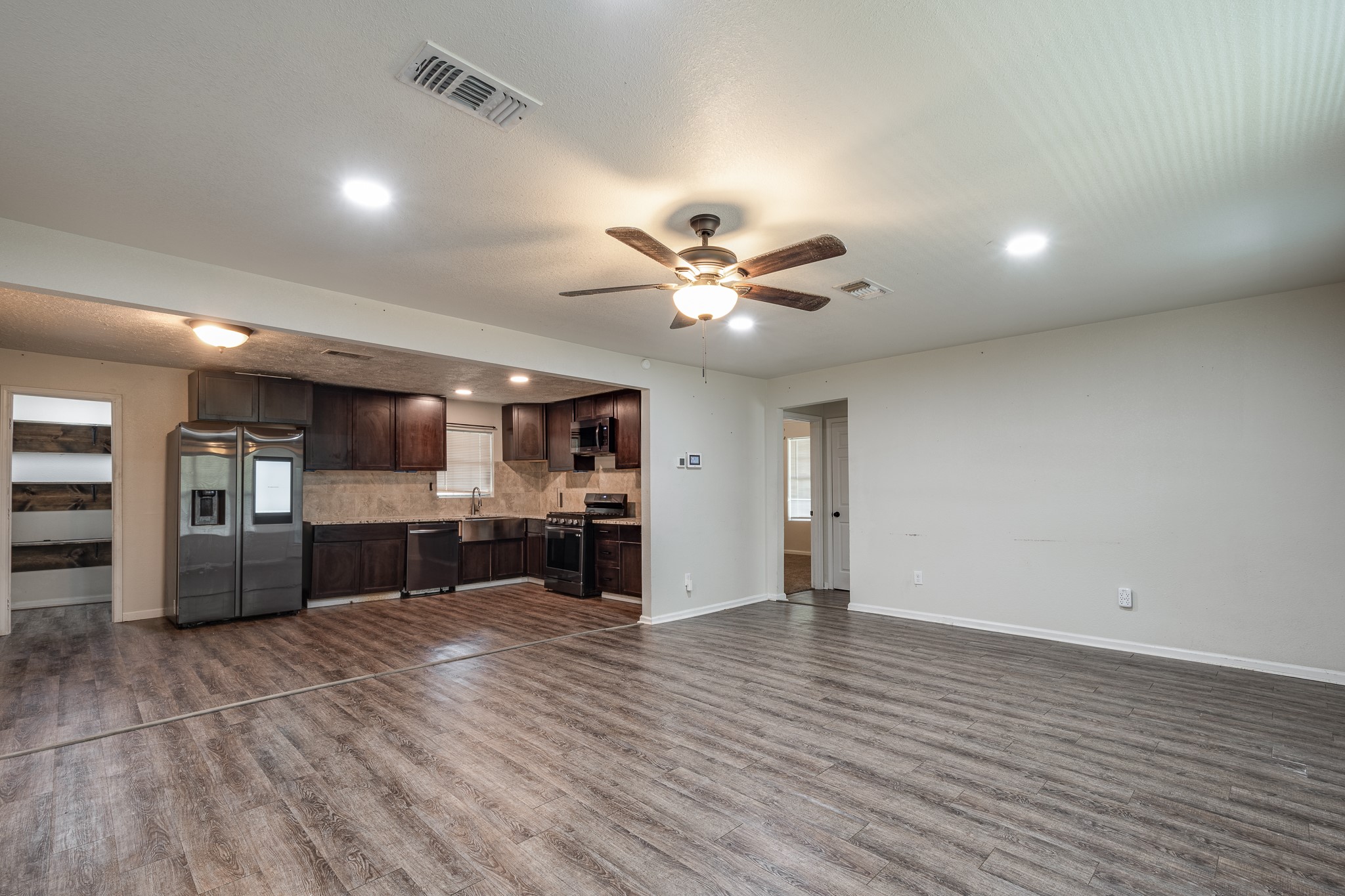 248 Fm-770 Liberty, TX 77575 - Photo 7 of 30 a view of a kitchen with a stove cabinets and wooden floor