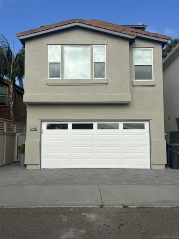 a front view of a house with a garage