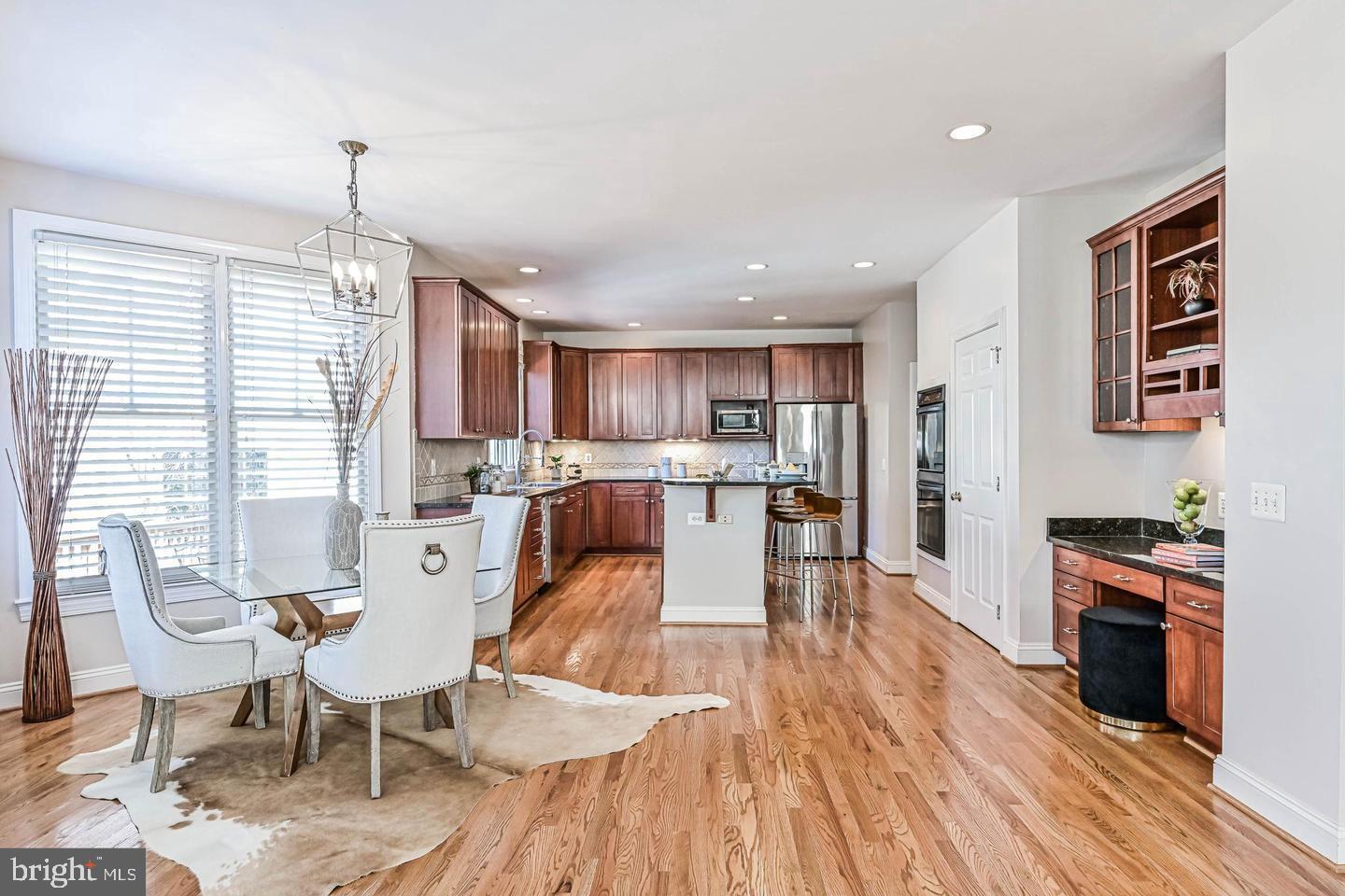 6516 76th Place Cabin John, MD 20818 - Photo 11 of 46 a living room with stainless steel appliances granite countertop furniture wooden floor and a kitchen view