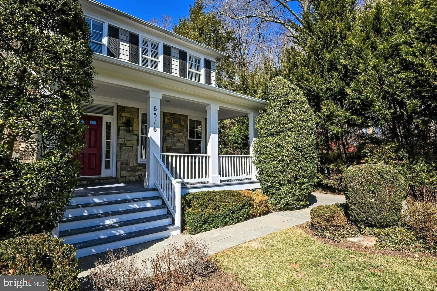 6516 76th Place Cabin John, MD 20818 - Photo 2 of 46 a view of a house with a large window and flower plants