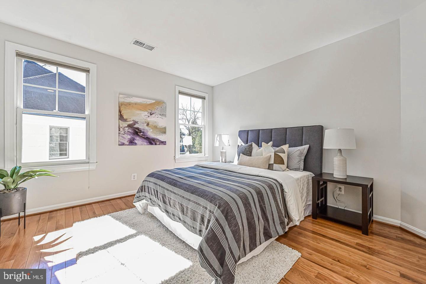 6516 76th Place Cabin John, MD 20818 - Photo 27 of 46 a bedroom with a bed and wooden floor