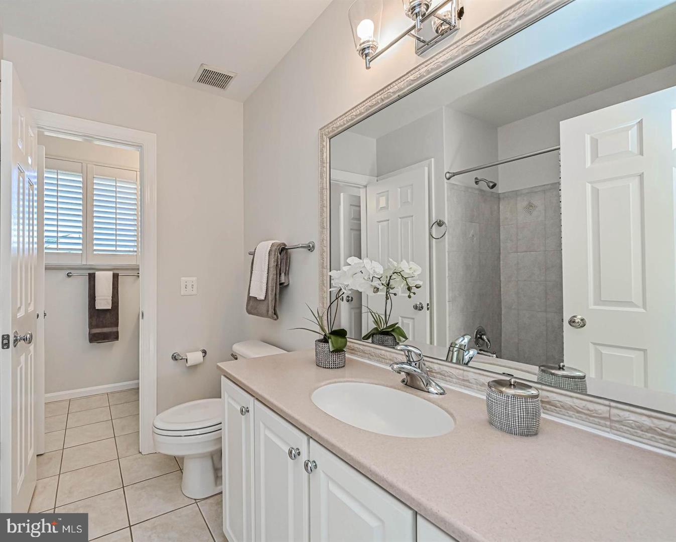 6516 76th Place Cabin John, MD 20818 - Photo 29 of 46 a bathroom with a double vanity sink toilet and shower