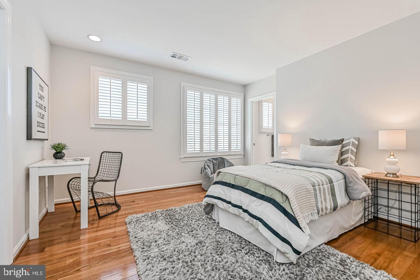 6516 76th Place Cabin John, MD 20818 - Photo 30 of 46 a bedroom with a bed a table and chair