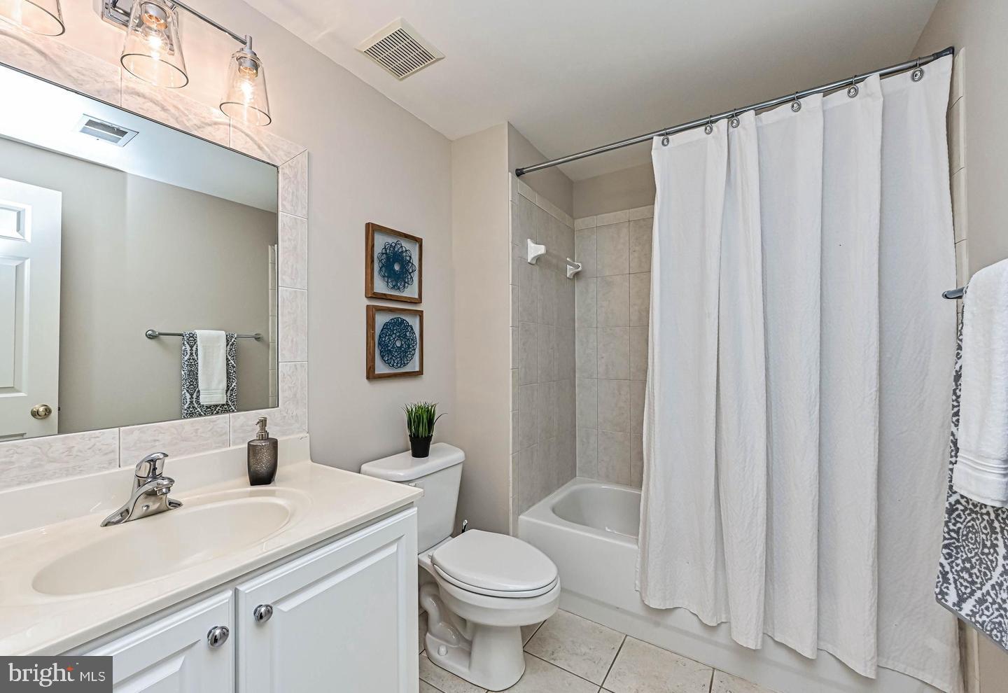 6516 76th Place Cabin John, MD 20818 - Photo 31 of 46 a bathroom with a sink toilet and shower