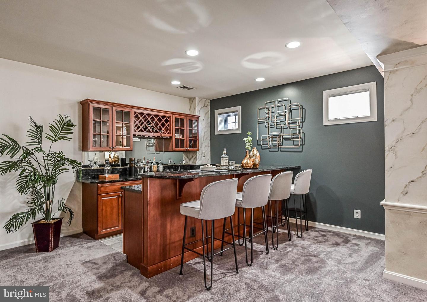 6516 76th Place Cabin John, MD 20818 - Photo 35 of 46 a kitchen with stainless steel appliances granite countertop sink stove and dining table