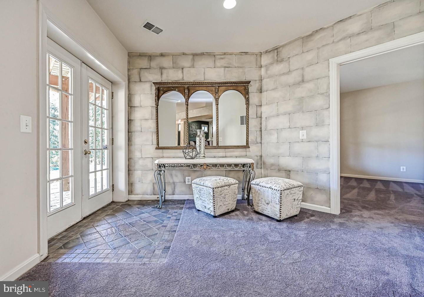 6516 76th Place Cabin John, MD 20818 - Photo 38 of 46 a living room with patio furniture and a floor to ceiling window
