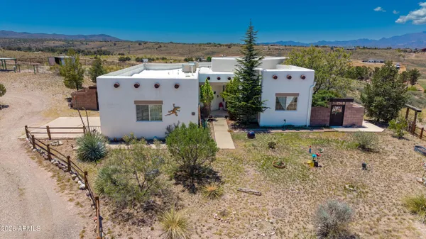 an aerial view of a house with a yard