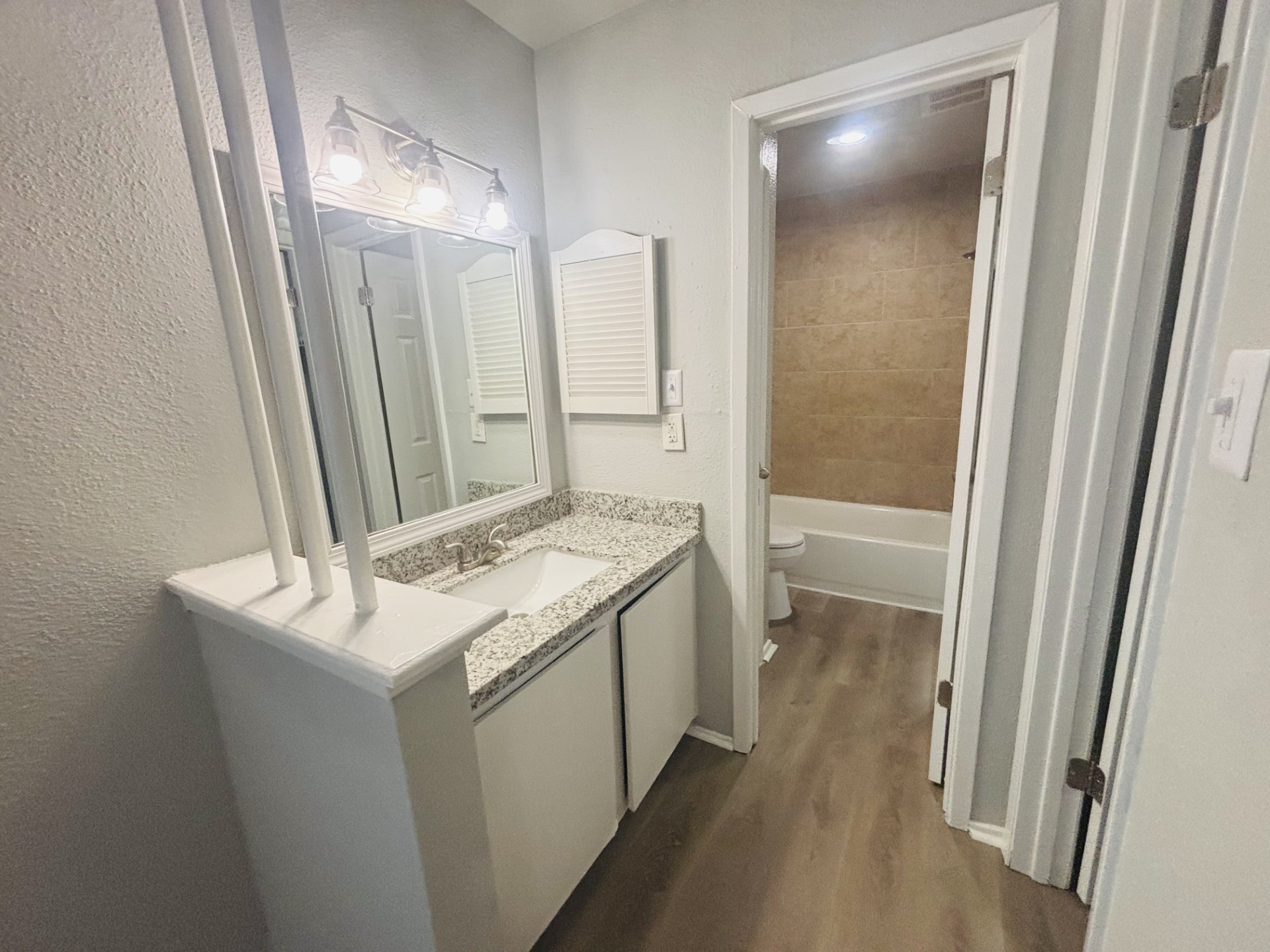 6200 West Tidwell Road, Unit 1109 Houston, TX 77092 - Photo 17 of 18 a bathroom with a sink a toilet and a mirror