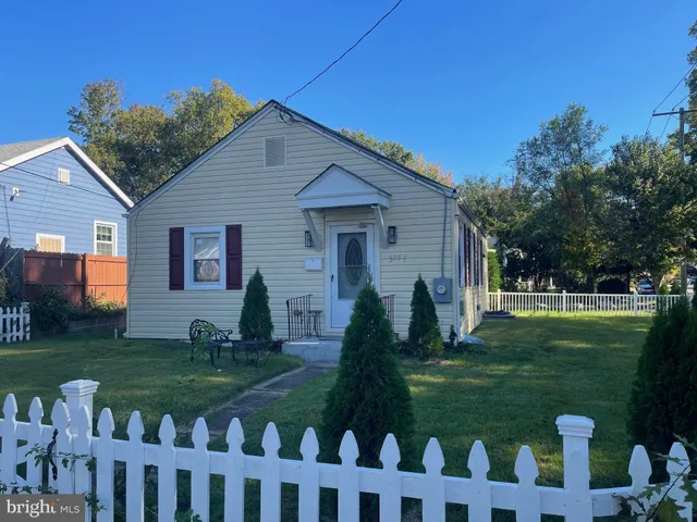 a front view of house with a garden
