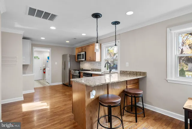 a view of kitchen and dining area with chandelier