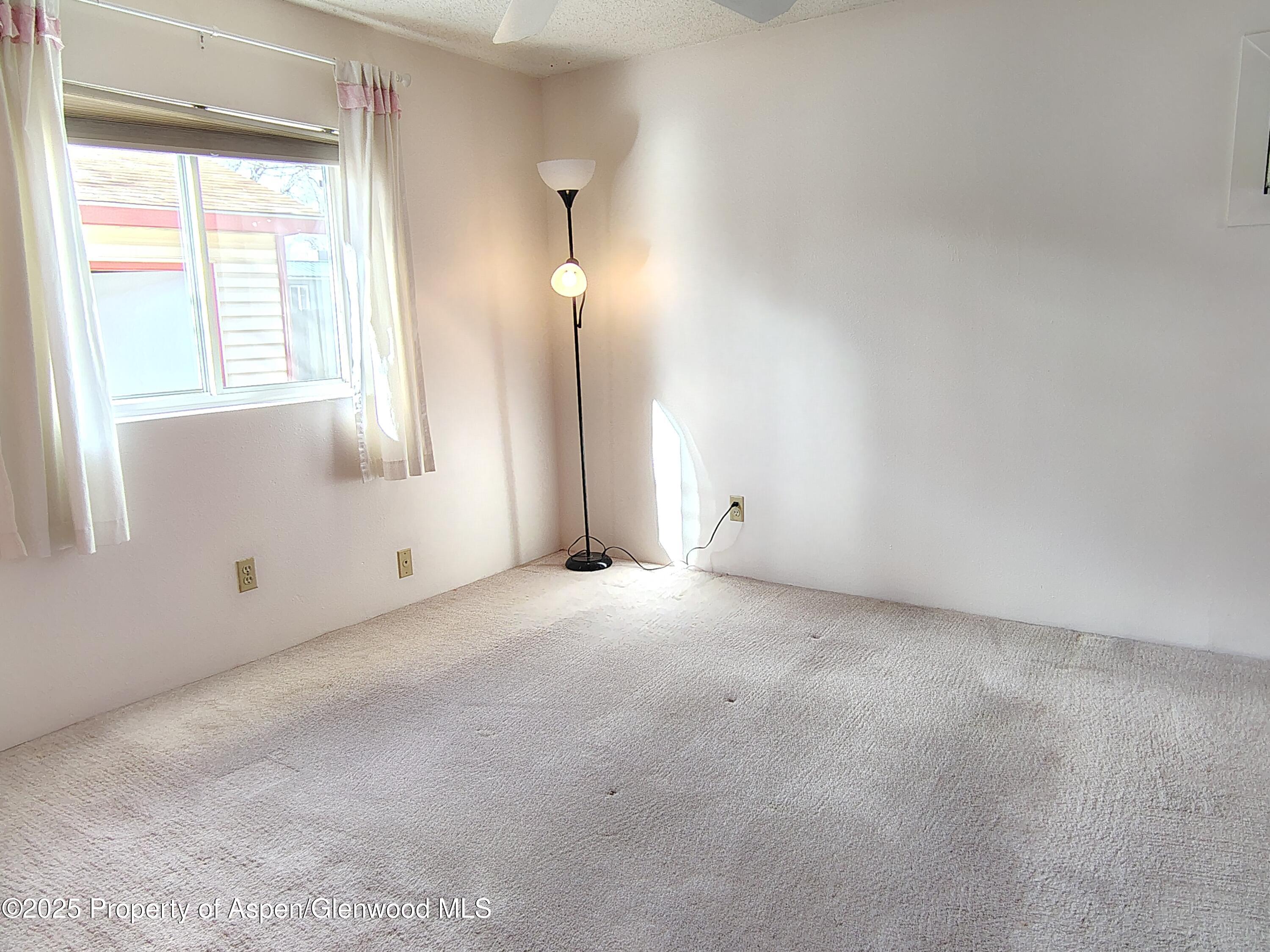 8 St John Circle Parachute, CO 81635 - Photo 11 of 32 an empty room with windows