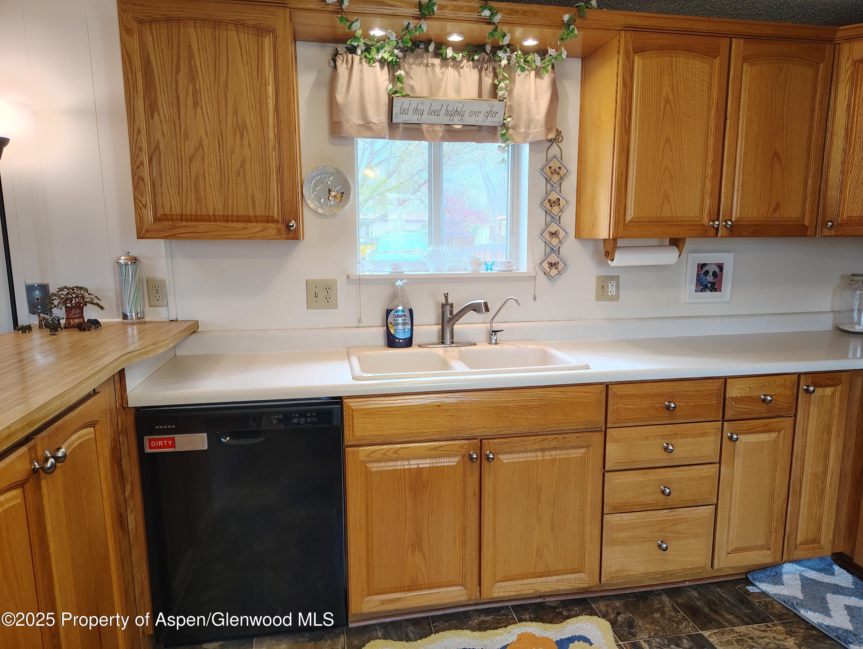 8 St John Circle Parachute, CO 81635 - Photo 14 of 32 a kitchen with stainless steel appliances a sink stove and cabinets