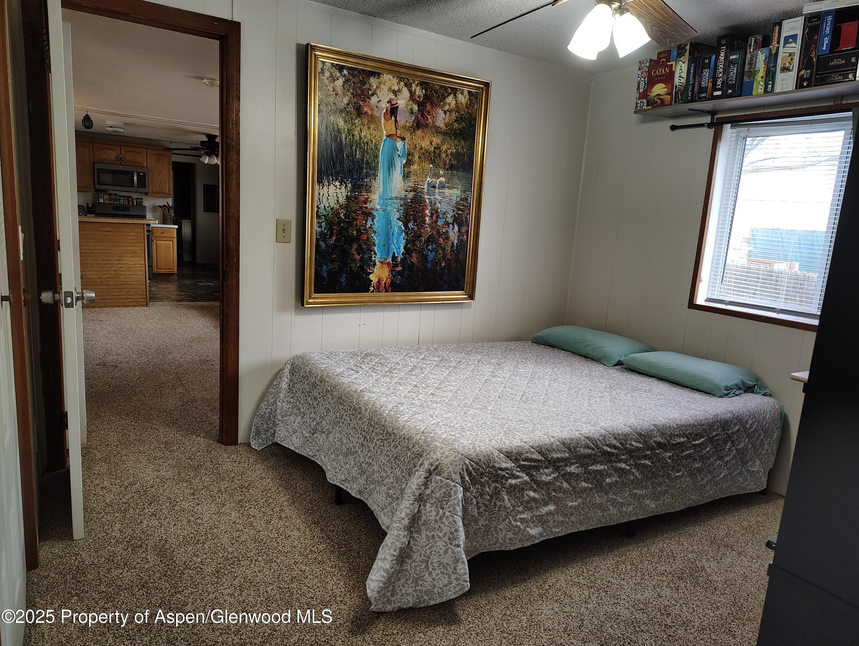 8 St John Circle Parachute, CO 81635 - Photo 16 of 32 a bedroom with a bed and a painting on the wall